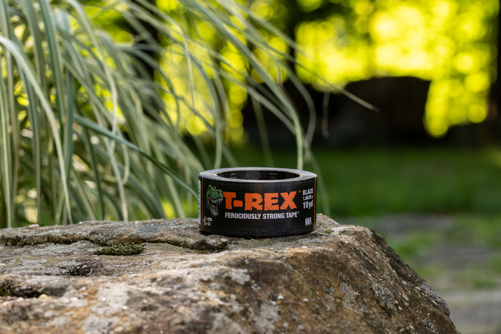 A 10 yd Roll of T-Rex Black Duct Tape on a sitting on a rock