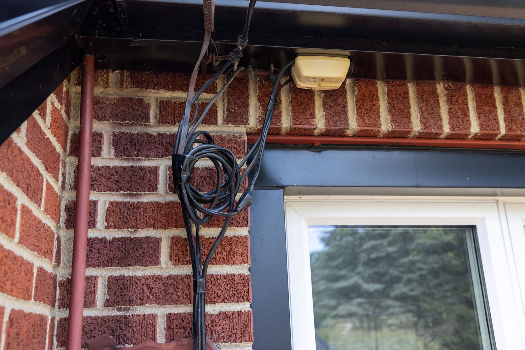A bundle of wires being held together with Black T-Rex Tape