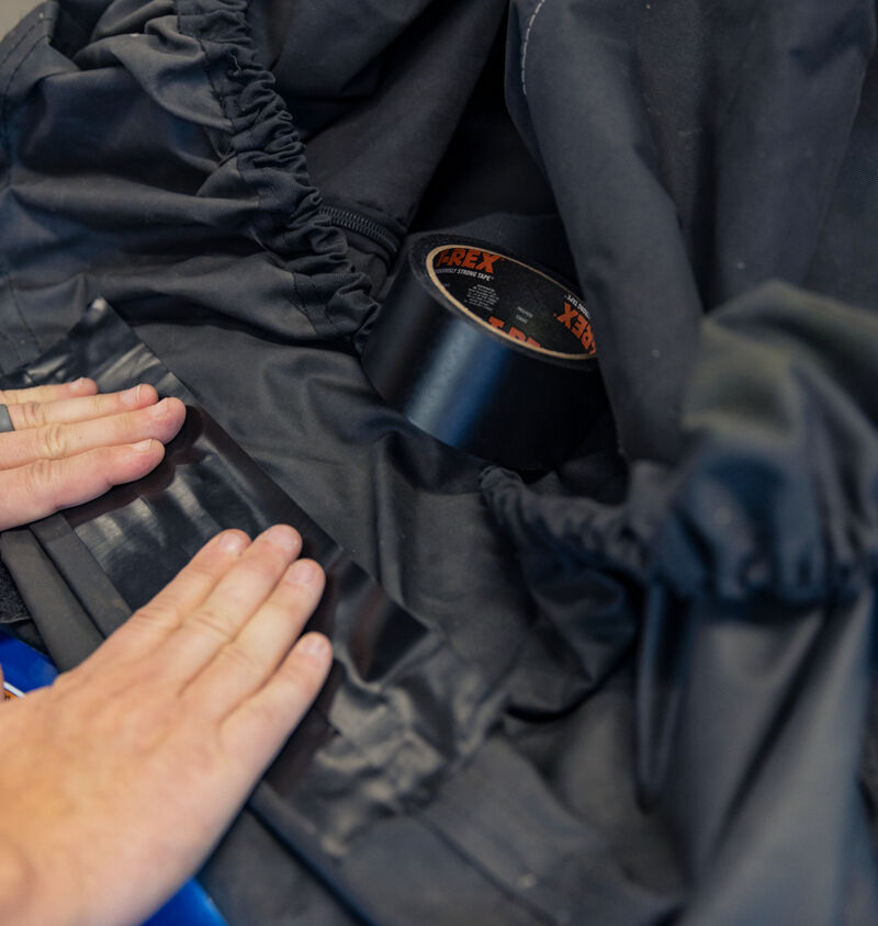 Black T-Rex Duct Tape being used to repair a cover