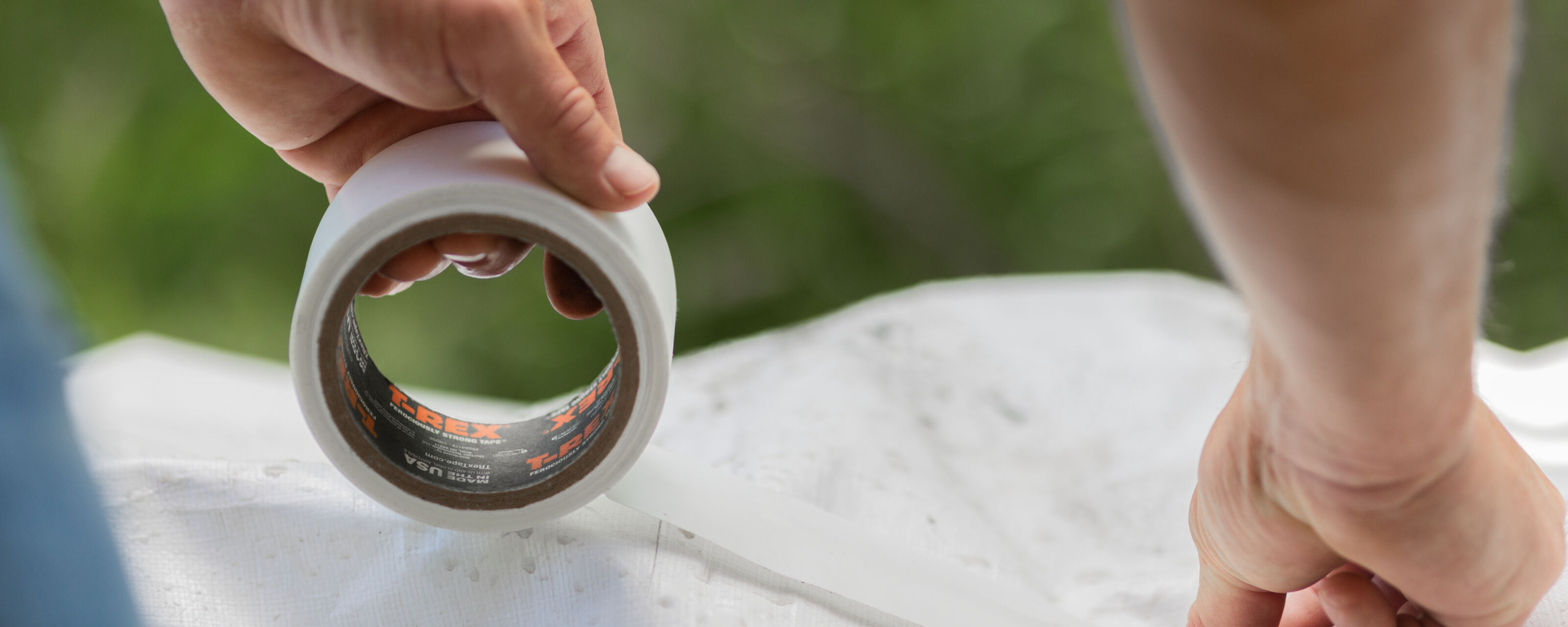 T-Rex Tape being used to repair a white tarp