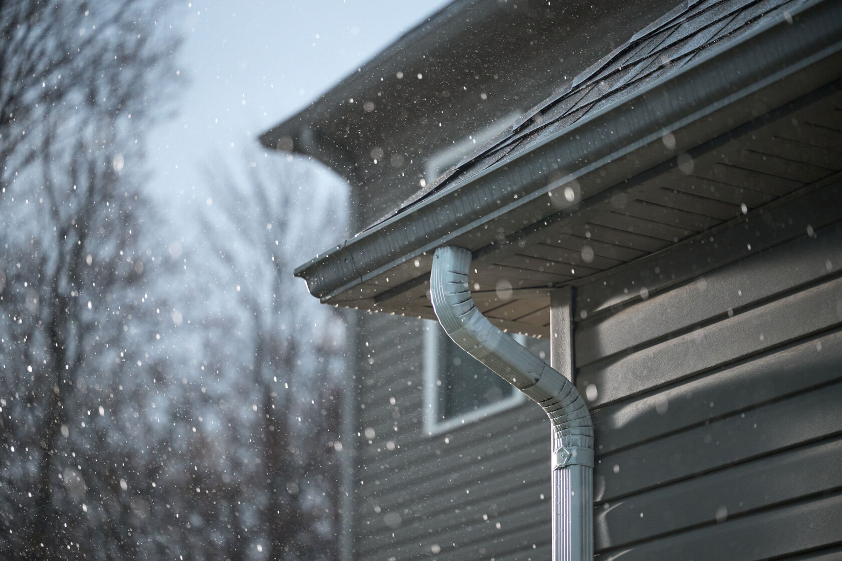 A Gutter on a home taped with White T-Rex Waterproof and Repair Tape in the winter time.