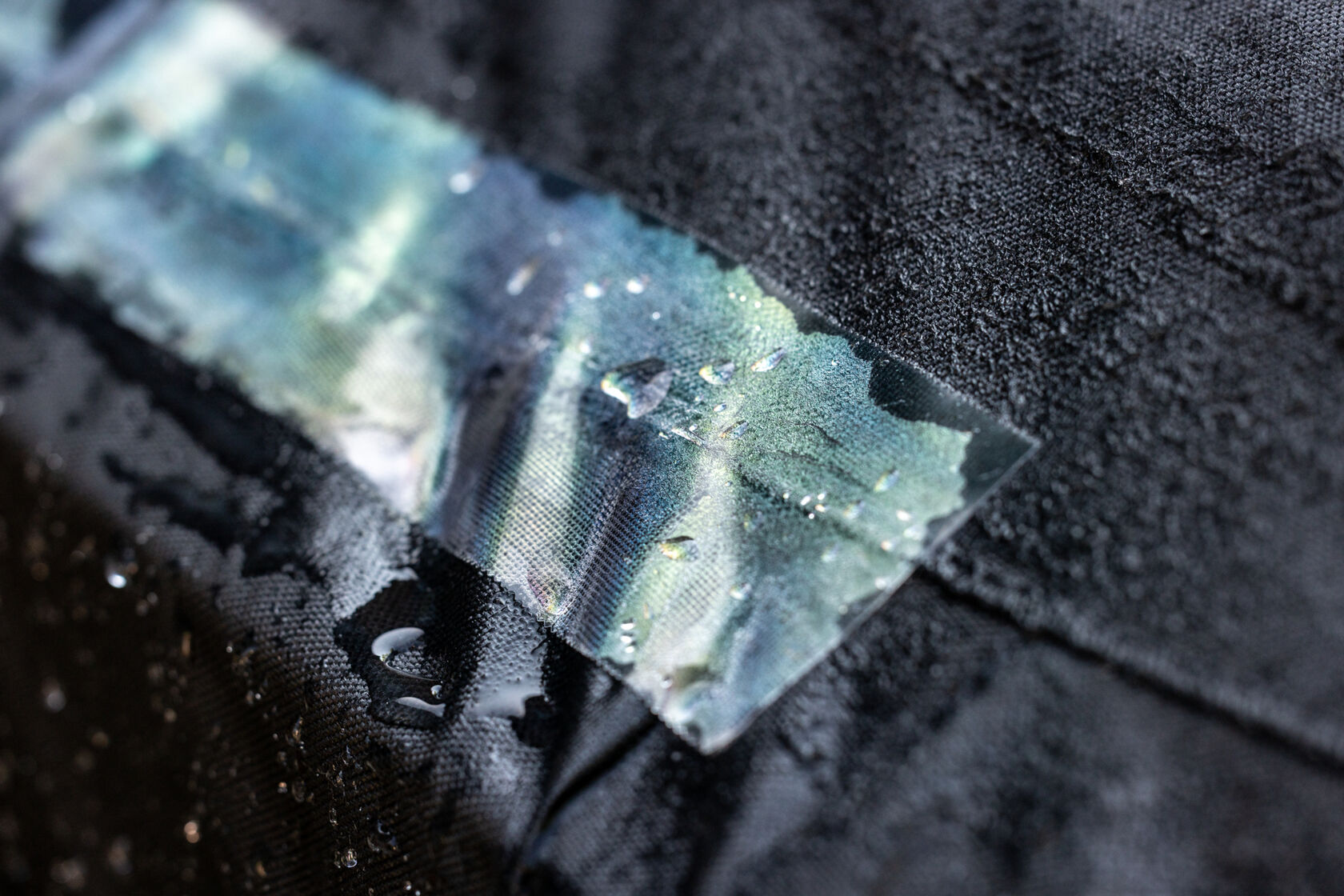 A black chair cover repaired with T-Rex Clear Repair Tape