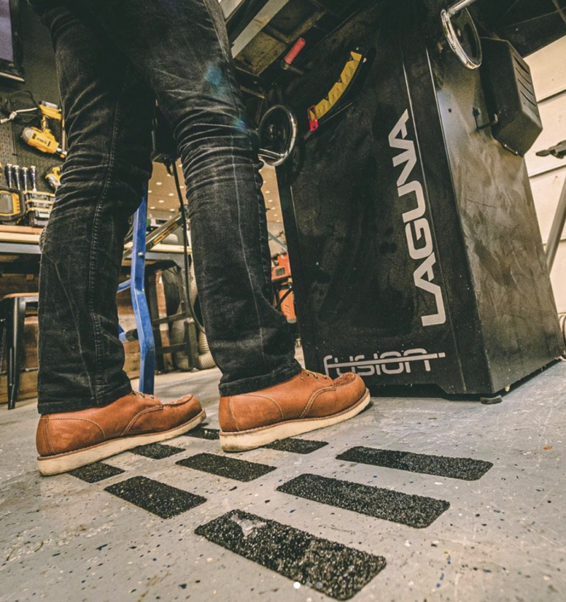 Man standing on strips of tread tape in a workshop